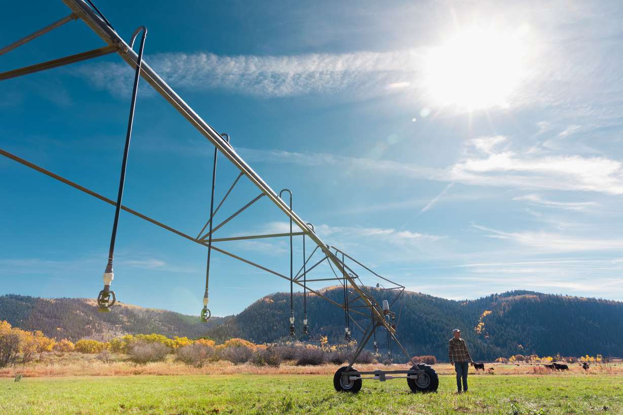 Steve Clyde stands by a pivot irrigation system at his ranch in Kamas on Oct. 15.