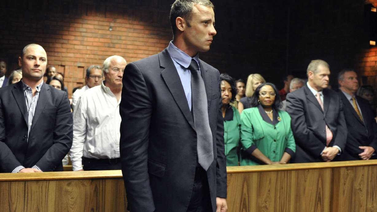 FILE - Olympian Oscar Pistorius stands following his bail hearing in Pretoria, South Africa, Tuesday, Feb. 19, 2013. Pistorius could be granted parole on Friday, Nov. 24, 2023 after nearly 10 years in prison for killing his girlfriend. The double-amputee Olympic runner was convicted of a charge comparable to third-degree murder for shooting Reeva Steenkamp in his home in 2013. He has been in prison since late 2014.
