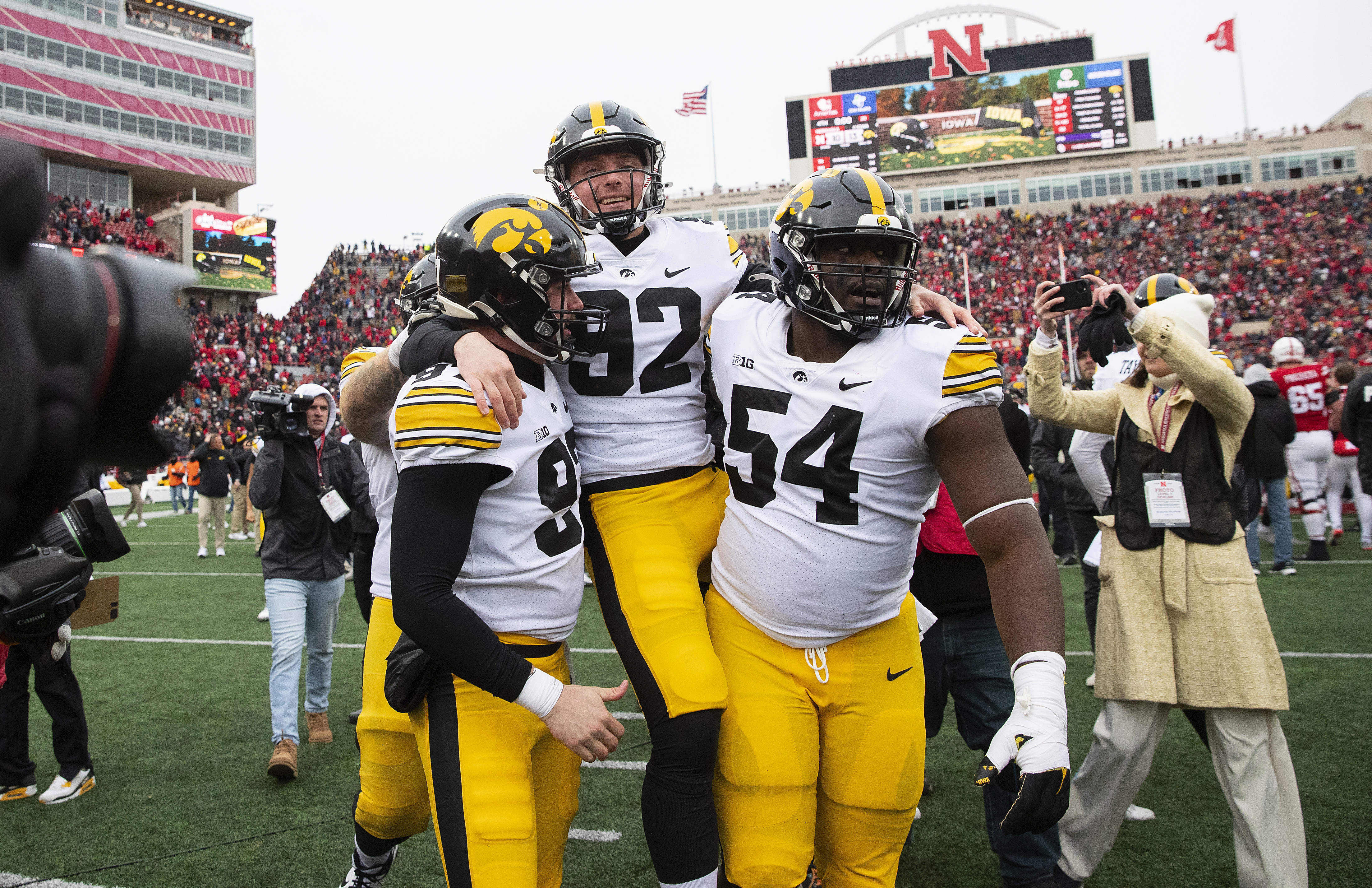 Iowa's Liam Reardon, left, and Anterio Thompson, right, carry kicker Marshall Meeder after he kicked a last-second field goal to defeat Nebraska 13-10 during an NCAA college football game, Friday, Nov. 24, 2023, in Lincoln, Neb.