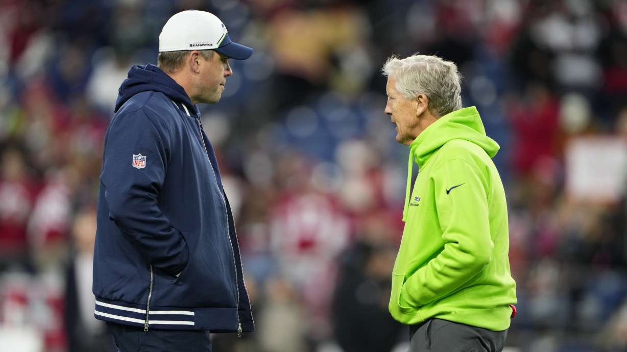 Seattle Seahawks offensive coordinator Shane Waldron, left, talks with head coach Pete Carroll before an NFL football game against the San Francisco 49ers, Thursday, Nov. 23, 2023, in Seattle.