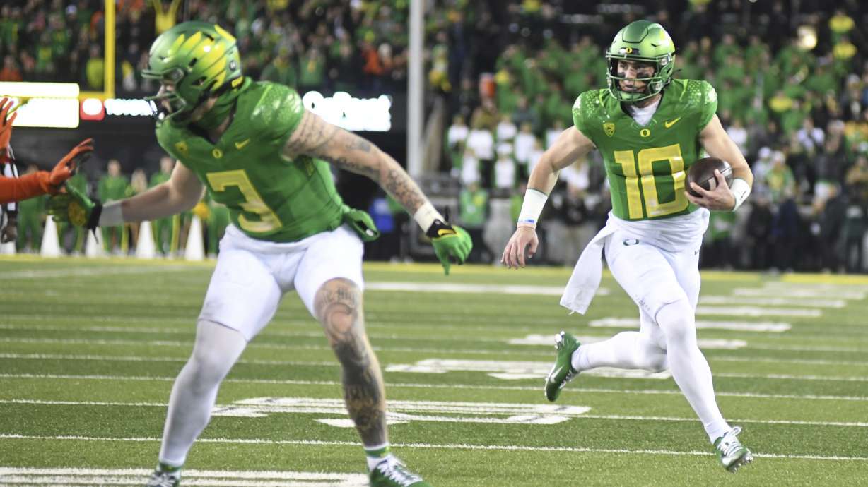 Oregon quarterback Bo Nix (10) runs for a touchdown during the first half of an NCAA college football game against Oregon State, Friday, Nov. 24, 2023, in Eugene, Ore.