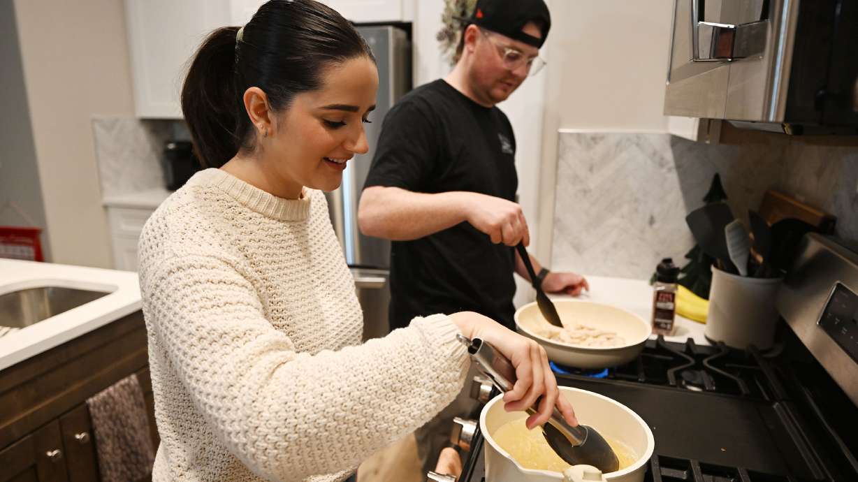 Kaitlyn Gordon and her husband, Zach Gordon, talk as they prepare a meal in their new home in Spanish Fork on Tuesday. 460 Utah homebuyers have taken advantage of the first-time homebuyer program.