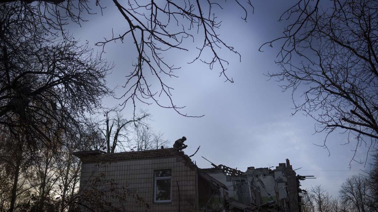 A Ukrainian serviceman stands atop a damaged kindergarten following a Russian drone attack in Kyiv, Ukraine, Saturday. Russia launched its most intense drone attack on Ukraine since the beginning of its full-scale invasion.