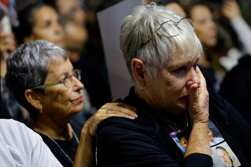 A woman reacts as people await news of hostages expected to be released by Hamas, amid a hostages-prisoners swap deal between Hamas and Israel, in Tel Aviv, Israel, Saturday.