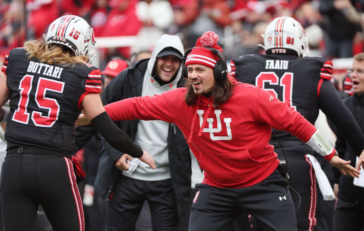 Utah Utes quarterback Cameron Rising (7) celebrates a touchdown with Utah Utes quarterback Luke Bottari (15) in Salt Lake City on Saturday, Nov. 25, 2023.