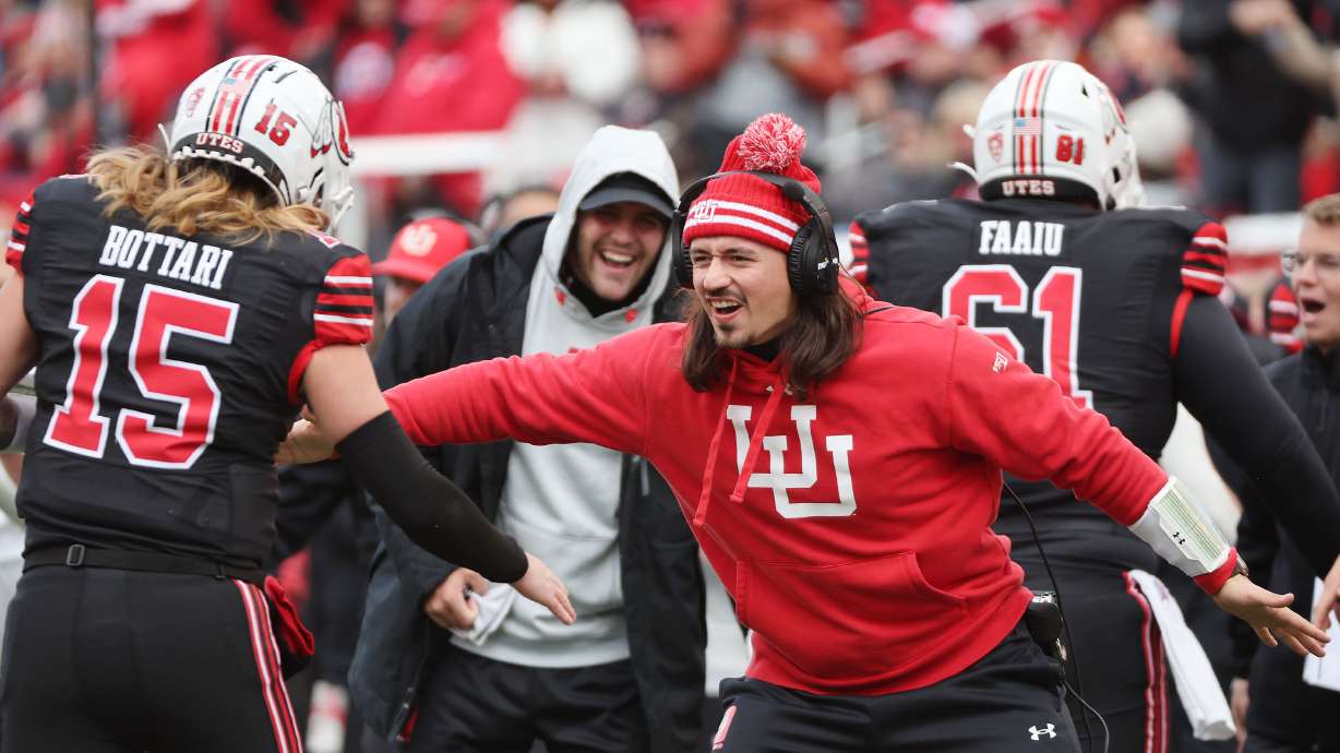 Utah Utes quarterback Cameron Rising (7) celebrates a touchdown with Utah Utes quarterback Luke Bottari (15) in Salt Lake City on Saturday, Nov. 25, 2023.