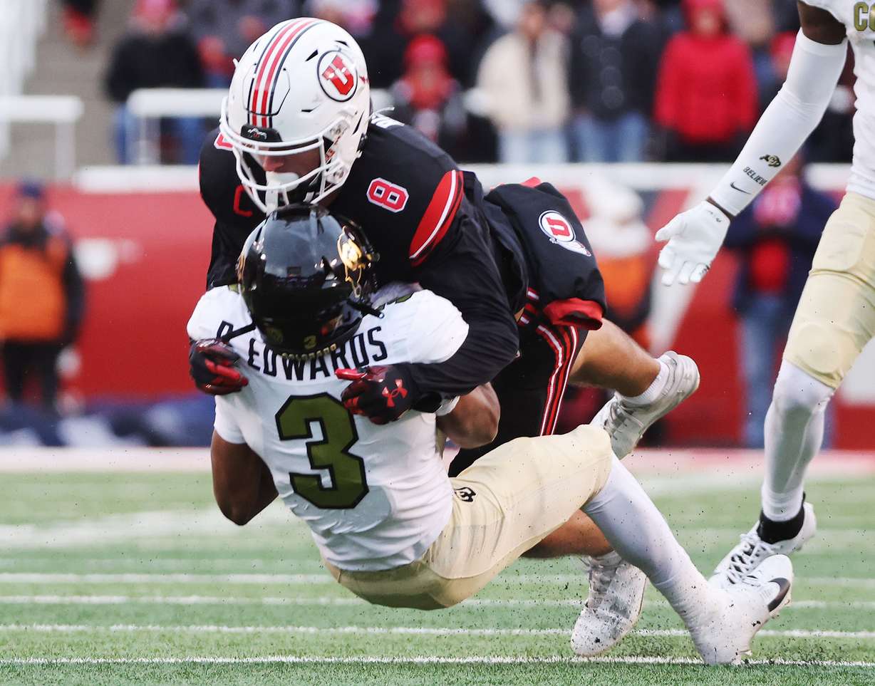 Utah Utes safety Cole Bishop (8) tackles Colorado Buffaloes running back Dylan Edwards (3) in Salt Lake City on Saturday, Nov. 25, 2023. Utah won 23-17.