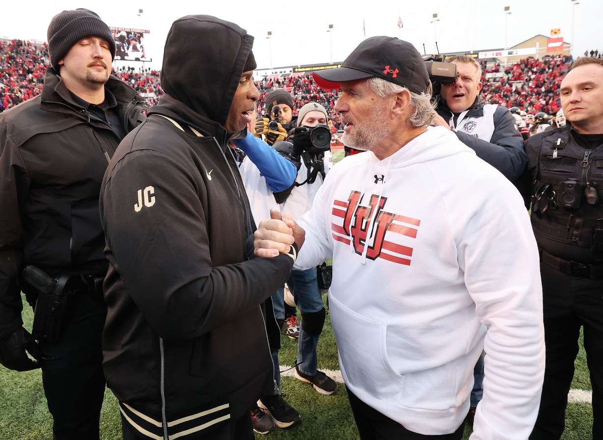 Utah Utes head coach Kyle Whittingham and Colorado Buffaloes head coach Deion Sanders meet at the end of the game in Salt Lake City on Saturday, Nov. 25, 2023. Utah won 23-17.