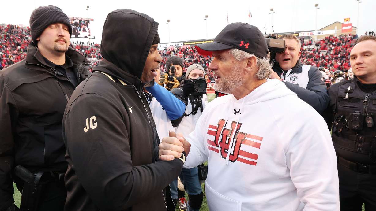 Utah Utes head coach Kyle Whittingham and Colorado Buffaloes head coach Deion Sanders meet at the end of the game in Salt Lake City on Saturday, Nov. 25, 2023. Utah won 23-17.