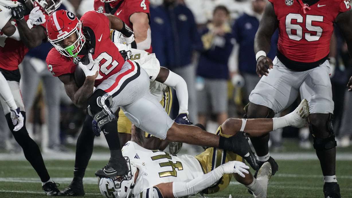 Georgia running back Kendall Milton (2) runs as Georgia Tech linebacker Kyle Efford (44) defends during the first half of an NCAA college football game, Saturday, Nov. 25, 2023, in Atlanta.