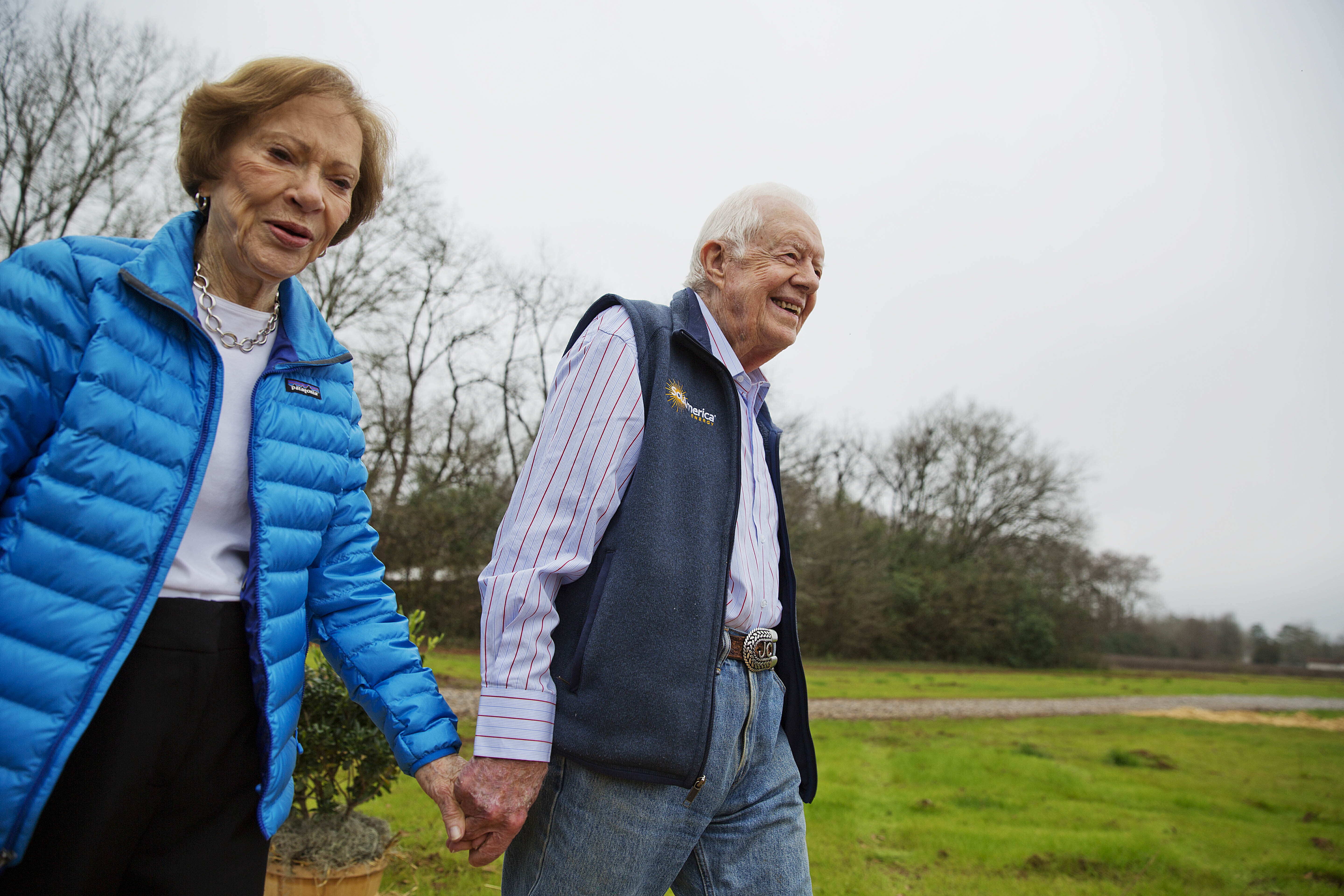 Former President Jimmy Carter, right, and his wife Rosalynn arrive for a ribbon cutting ceremony for a solar panel project on farmland he owns in their hometown of Plains, Georgia on Feb. 8, 2017.