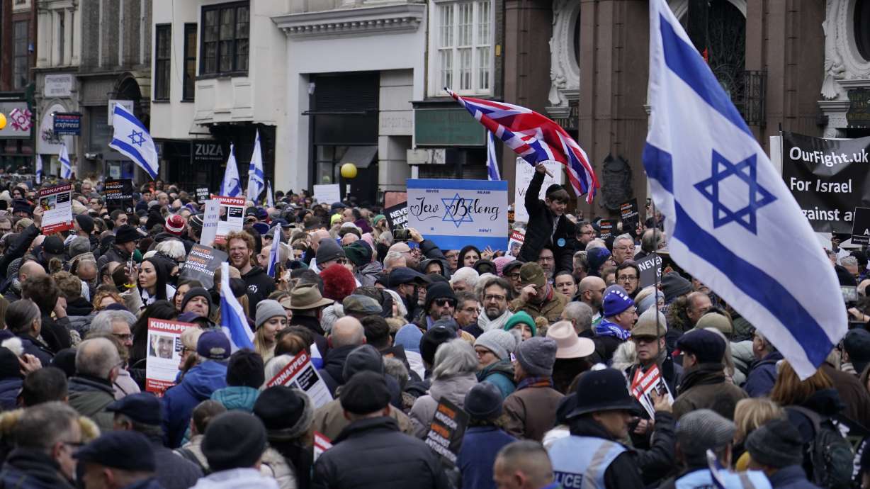 Protesters holding placards flags and banners, including the flag of Israel, during an antisemitism demonstration in London, Sunday.