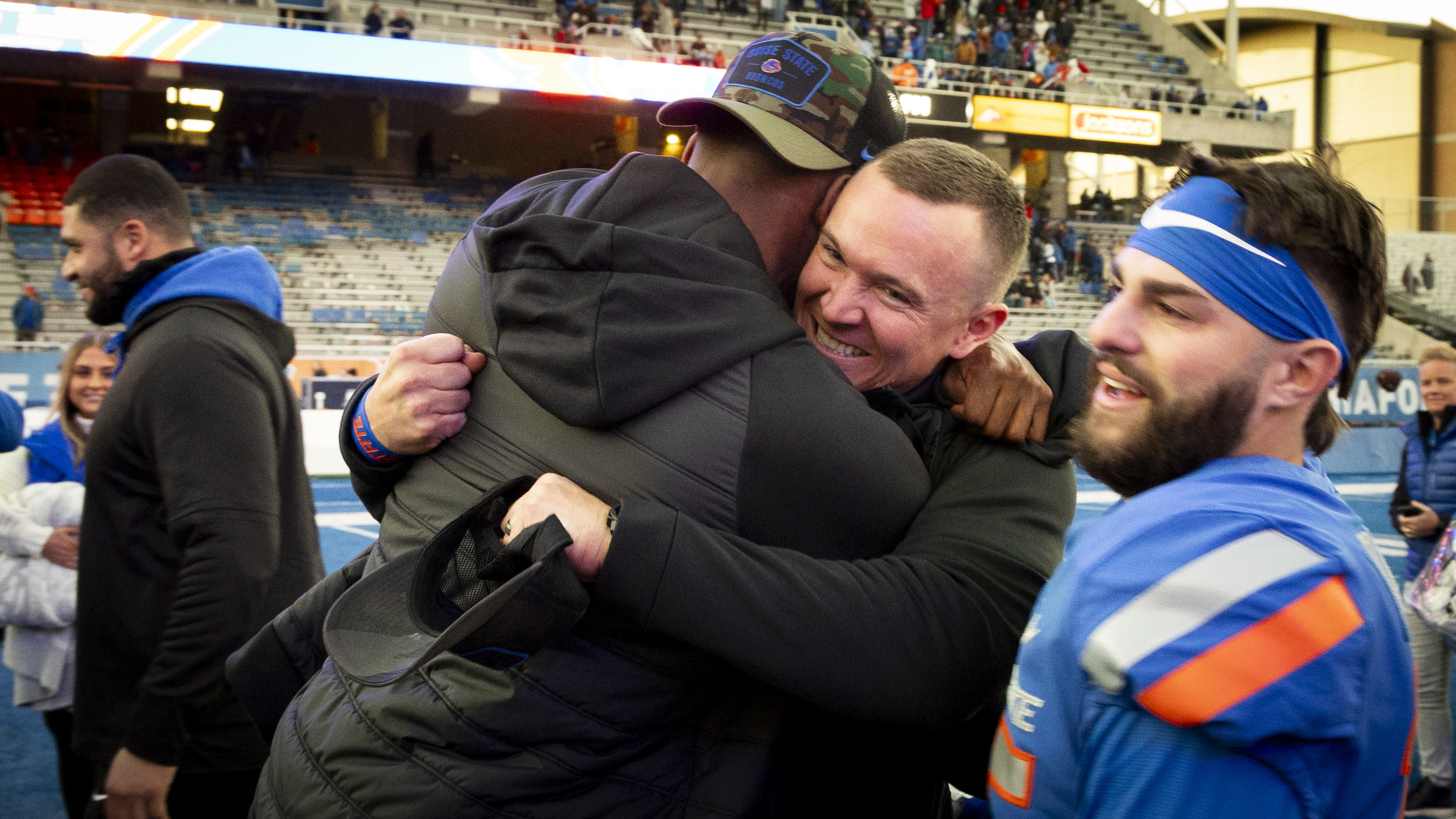 Boise State interim coach Spencer Danielson hugs a member of the coaching staff following the team's win over Air Force in an NCAA college football game Friday, Nov. 24, 2023, in Boise, Idaho. 