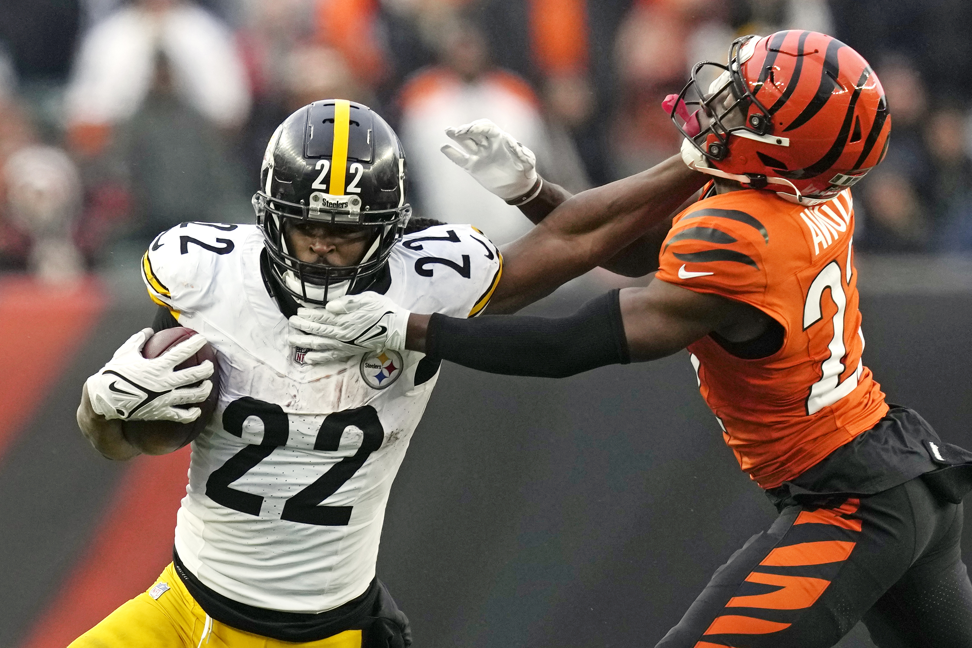Pittsburgh Steelers running back Najee Harris (22) stiff arms Cincinnati Bengals cornerback Mike Hilton (21) during the second half of an NFL football game in Cincinnati, Sunday, Nov. 26, 2023. The Steelers won 16-10. 