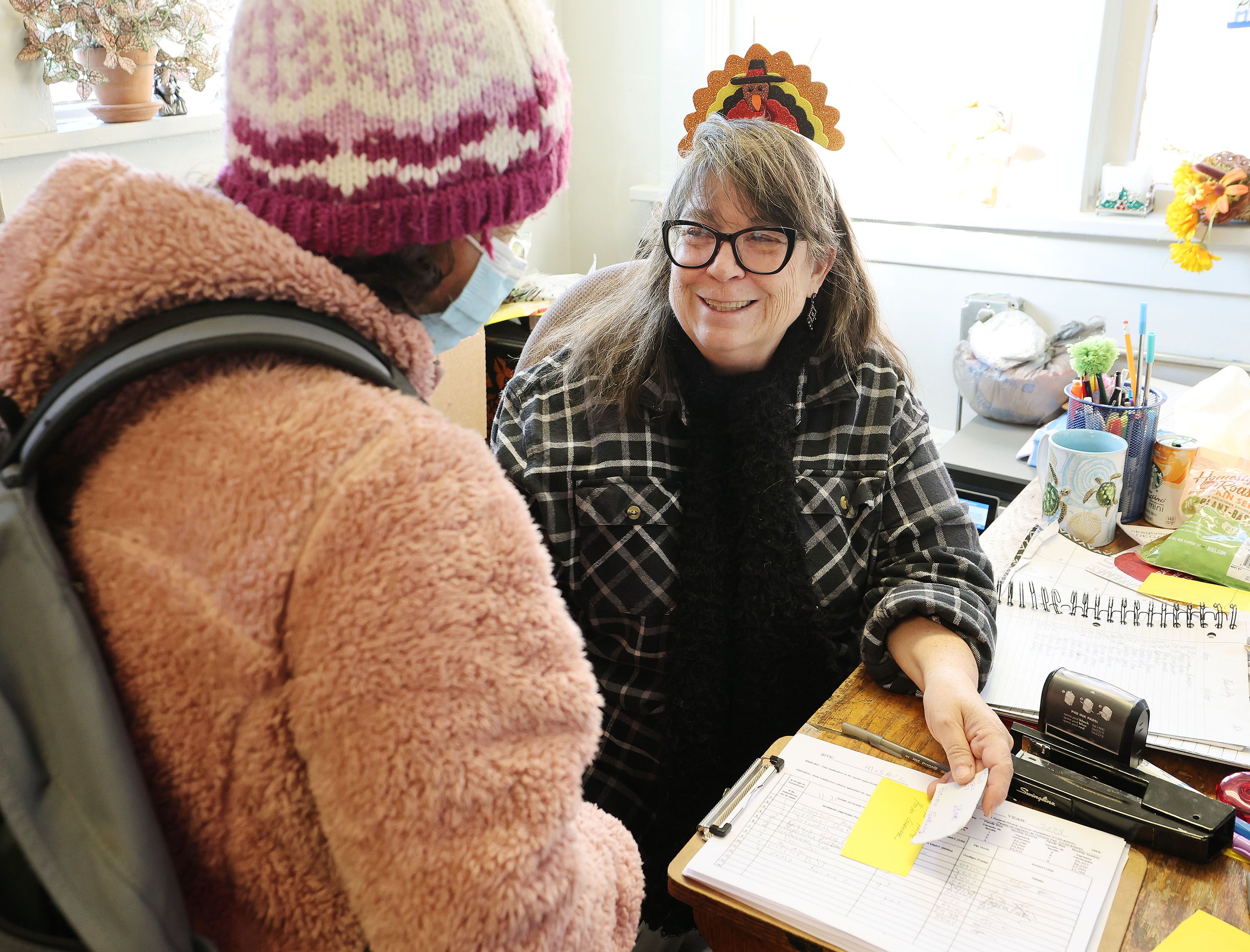 The Rev. Dr. Leslie Whited, director of Mosaic Inter-Faith Ministries, talks with a client while handing out Thanksgiving meals in Salt Lake City on Nov. 21.