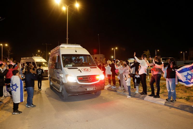 People react to the convoy carrying newly released hostages that were seized during the Oct. 7 attack by Palestinian militant group Hamas and held in the Gaza Strip, in Ofakim, Israel, Sunday.