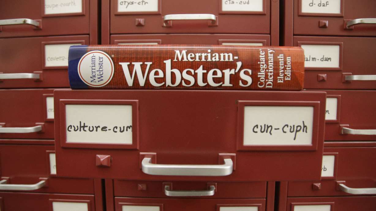A Merriam-Webster dictionary sits atop citation files at the dictionary publisher's offices on Dec. 9, 2014, in Springfield, Mass. Merriam-Webster unveiled its word of the year for 2023 Monday.