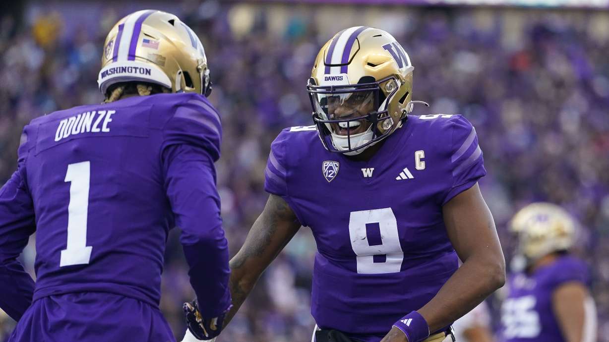 Washington quarterback Michael Penix Jr. (9) celebrates throwing a touchdown to wide receiver Rome Odunze (1) against Washington State during the first half of an NCAA college football game, Saturday, Nov. 25, 2023, in Seattle.