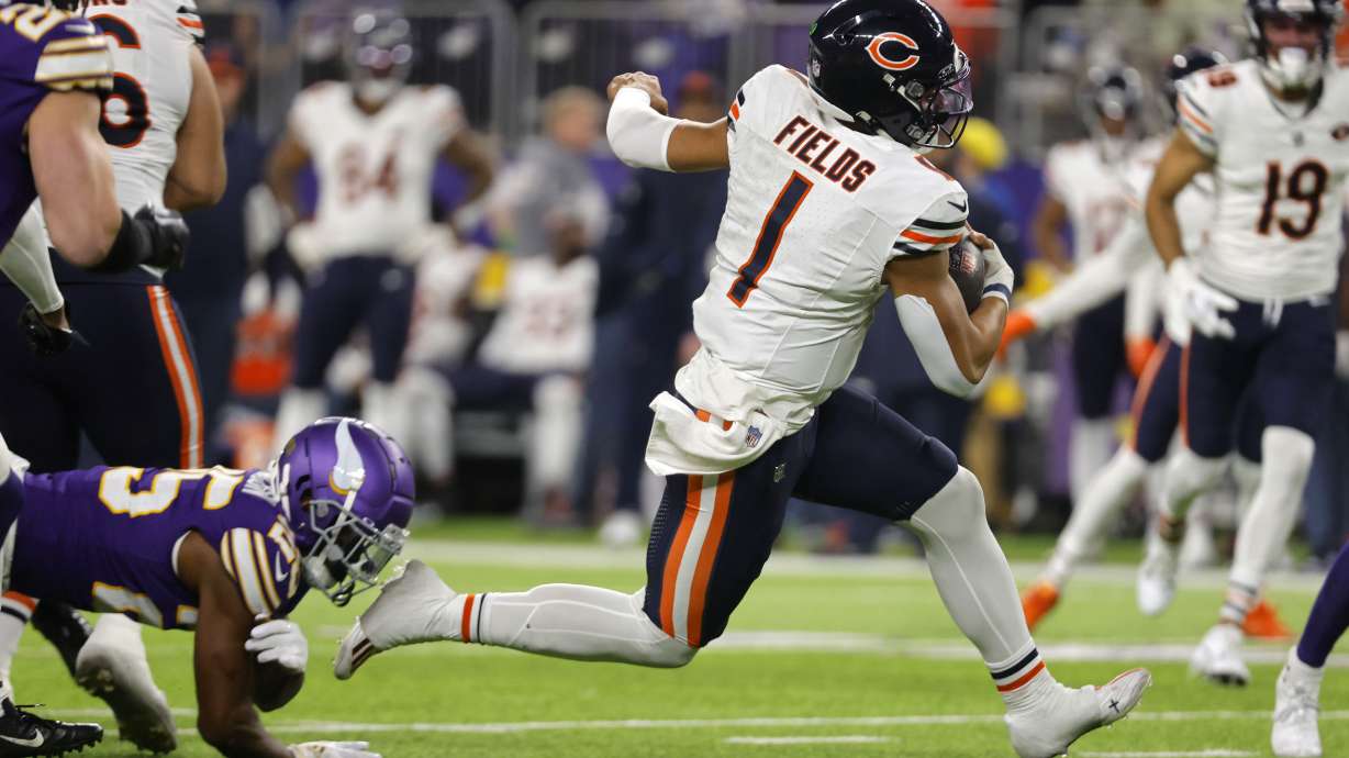 Chicago Bears quarterback Justin Fields (1) runs up field during the second half of an NFL football game against the Minnesota Vikings, Monday, Nov. 27, 2023, in Minneapolis.
