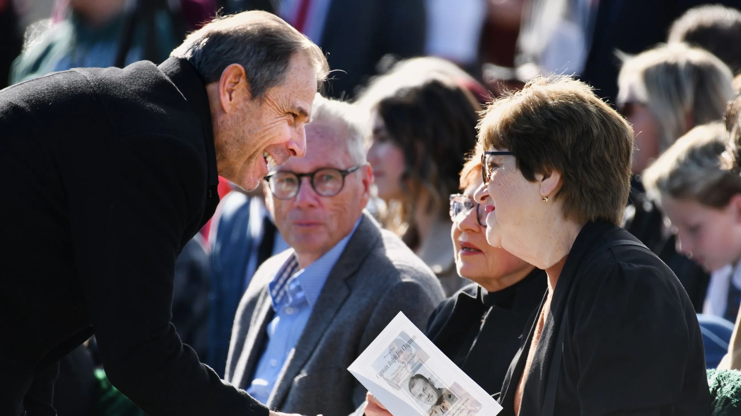 U.S. Rep. John Curtis, R-Utah, greets the family of U.S. Marine Corps Capt. Ralph Jim Chipman during a memorial service at American Fork city cemetery on Nov. 11. Curtis looks increasingly likely to swap a 2024 House campaign for a Senate run.
