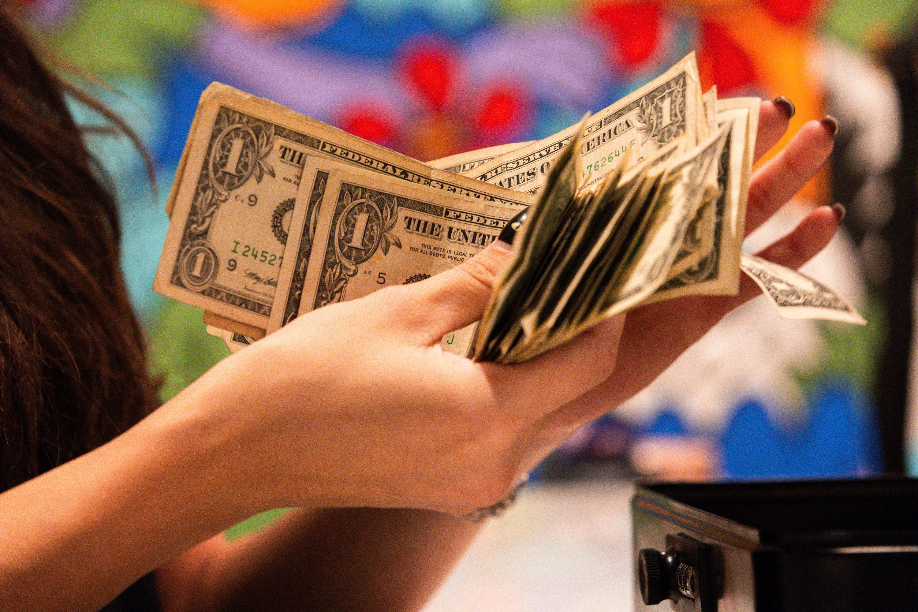 Brook Anderson counts cash from the cash box on Black Friday at Thread at City Creek Center in Salt Lake City on Friday, Nov. 24.