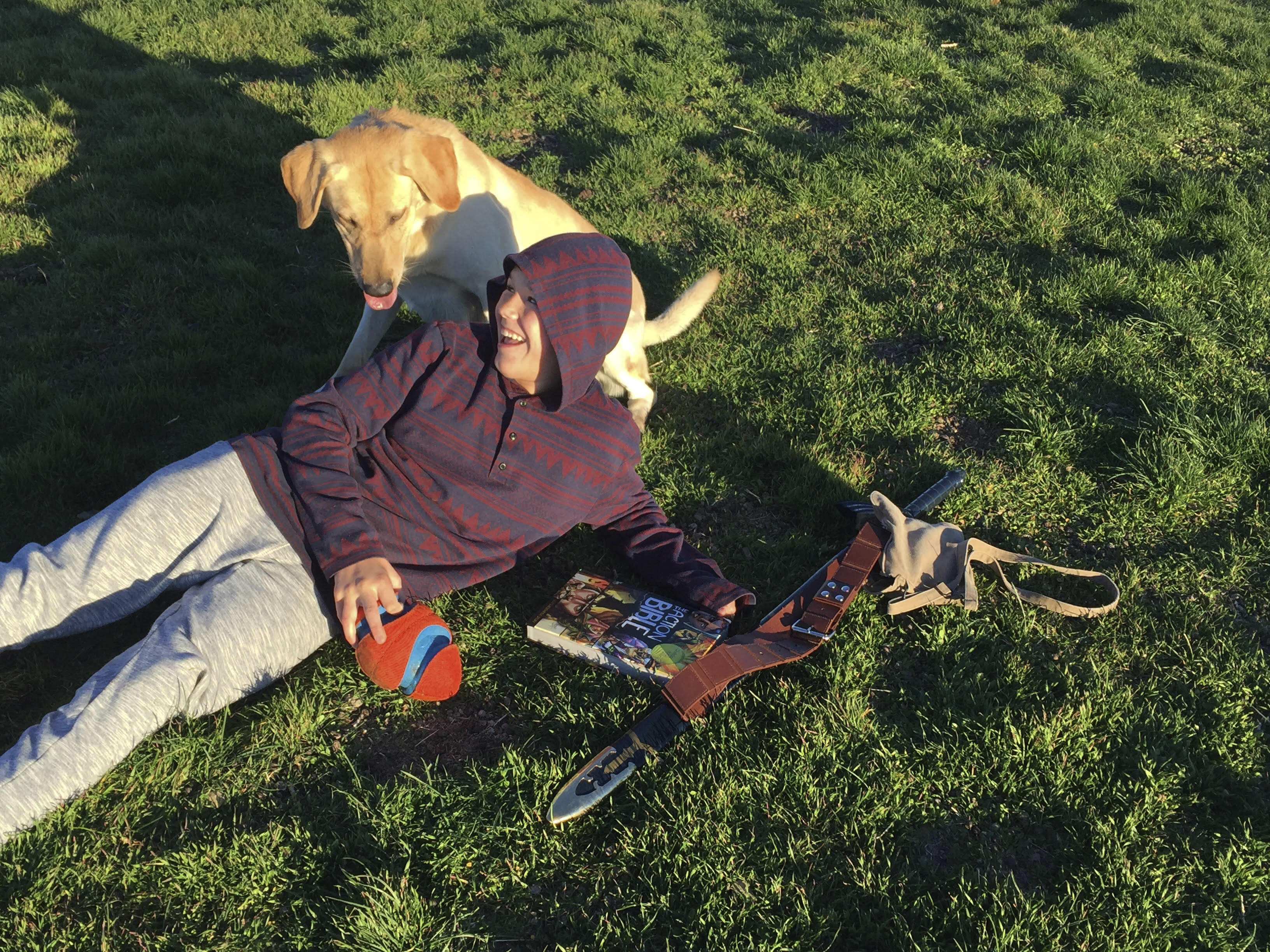 Canyon Mansfield and dog Kasey play in the grass in Pocatello, Idaho. The boy was seriously injured in 2017 and his dog was killed when a cyanide device that is used to kill certain predators emitted a cloud of poison. A U.S. agency decided to end the use of the devices on public lands.