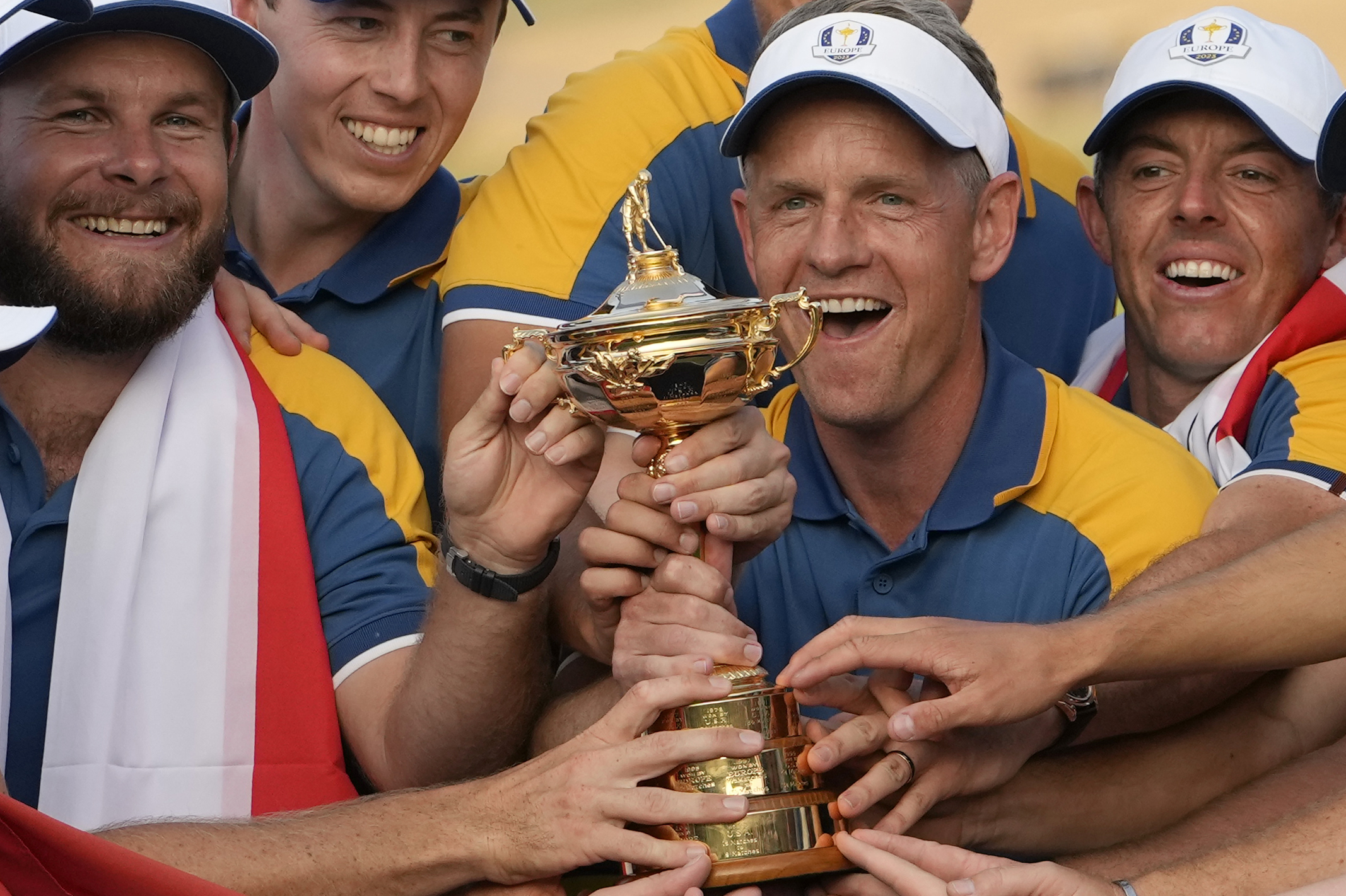 FILE - Europe's Team Captain Luke Donald, centre, and team members lift the Ryder Cup after winning the trophy by defeating the United States 16/12 point to 11 1/2 points at the Marco Simone Golf Club in Guidonia Montecelio, Italy, on Oct. 1, 2023. Luke Donald is staying on as captain of the European team for its defense of the Ryder Cup in 2025 at Bethpage Black. The 45-year-old Donald led the Europeans to a 16½-11½ victory over the United States outside Rome last month and the European tour said Wednesday Nov. 29, 2023 he is being retained as captain.