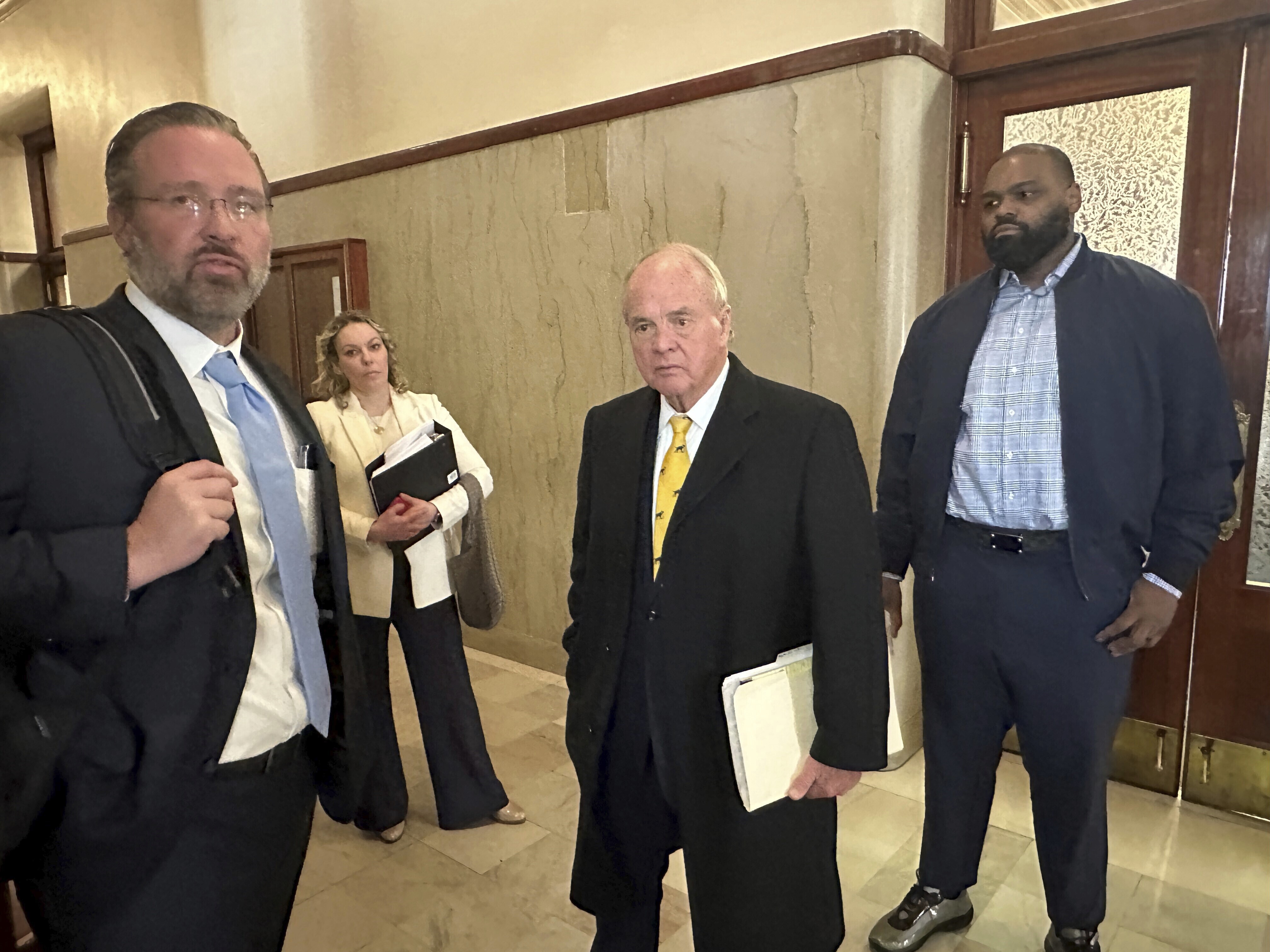 Former NFL football player Michael Oher, right, stands with his lawyers outside a courtroom, Wednesday, Nov. 29, 2023, in Memphis, Tenn. A lawyer for the Memphis couple who took in former NFL player Michael Oher when he was in high school said Wednesday, Nov. 29, 2023, that references to Oher being their adopted son will be removed from the couple’s websites and public speaking materials as part of their legal battle over Oher’s finances.