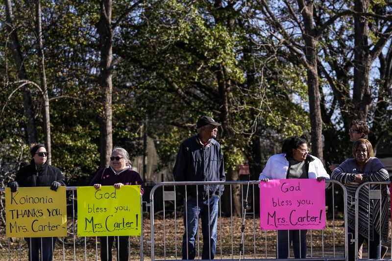 People watch the motorcade as it moves to Maranatha Baptist Church where the funeral service for former first lady Rosalynn Carter will be held, Wednesday in Plains, Ga. The former first lady died on Nov. 19. She was 96.