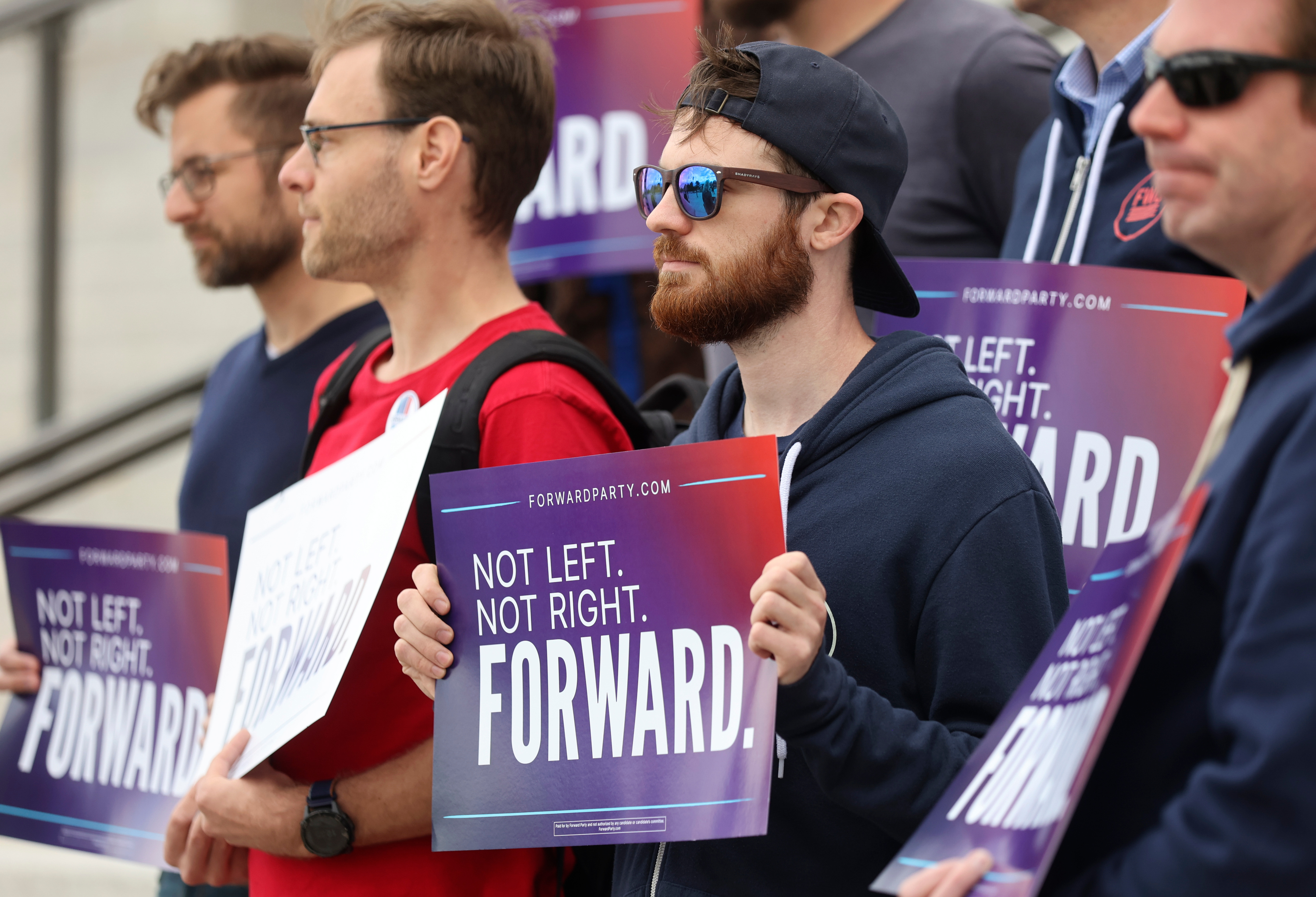 Supporters hold signs during a press conference to announce Utah Forward Party’s collection of more than 2,000 petition signatures, which is required to put the party on voting ballots, outside of the Capitol in Salt Lake City on Oct. 11.