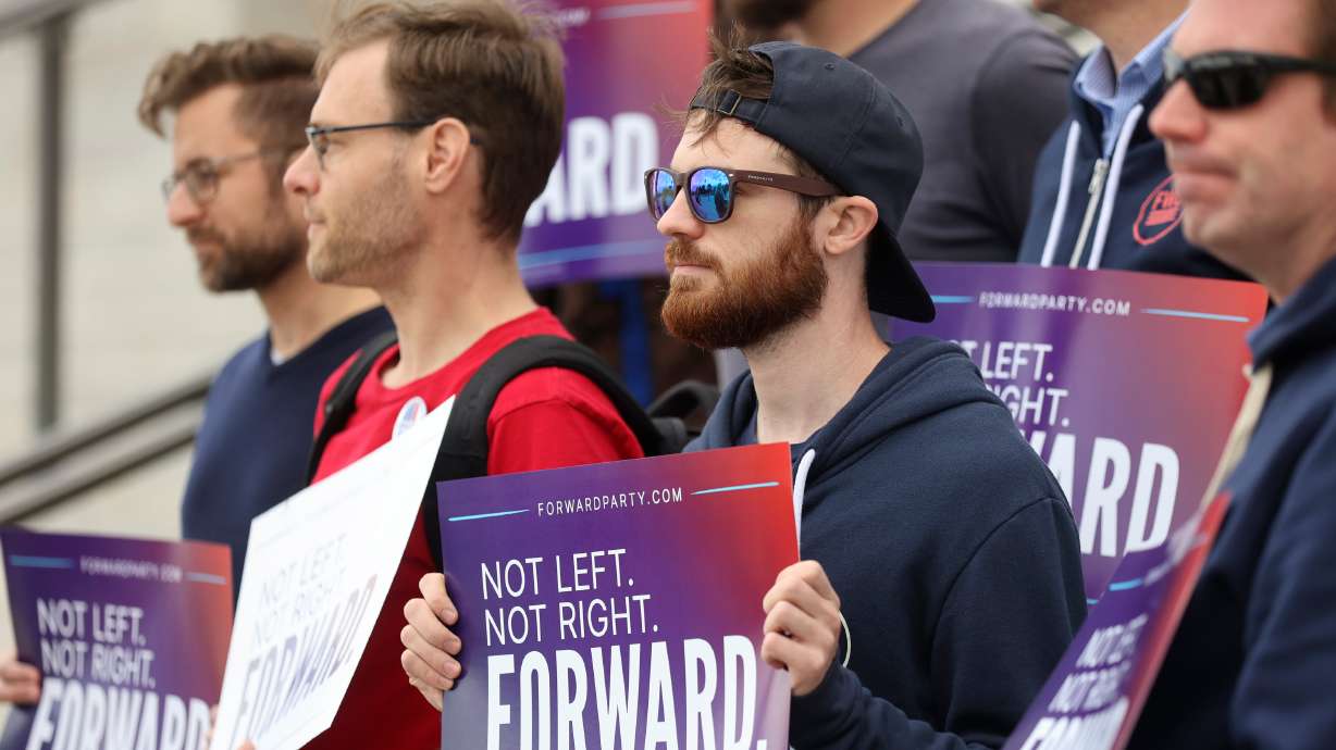 Supporters hold signs during a press conference to announce Utah Forward Party’s collection of more than 2,000 petition signatures, which is required to put the party on voting ballots, outside of the Capitol in Salt Lake City on Oct. 11.