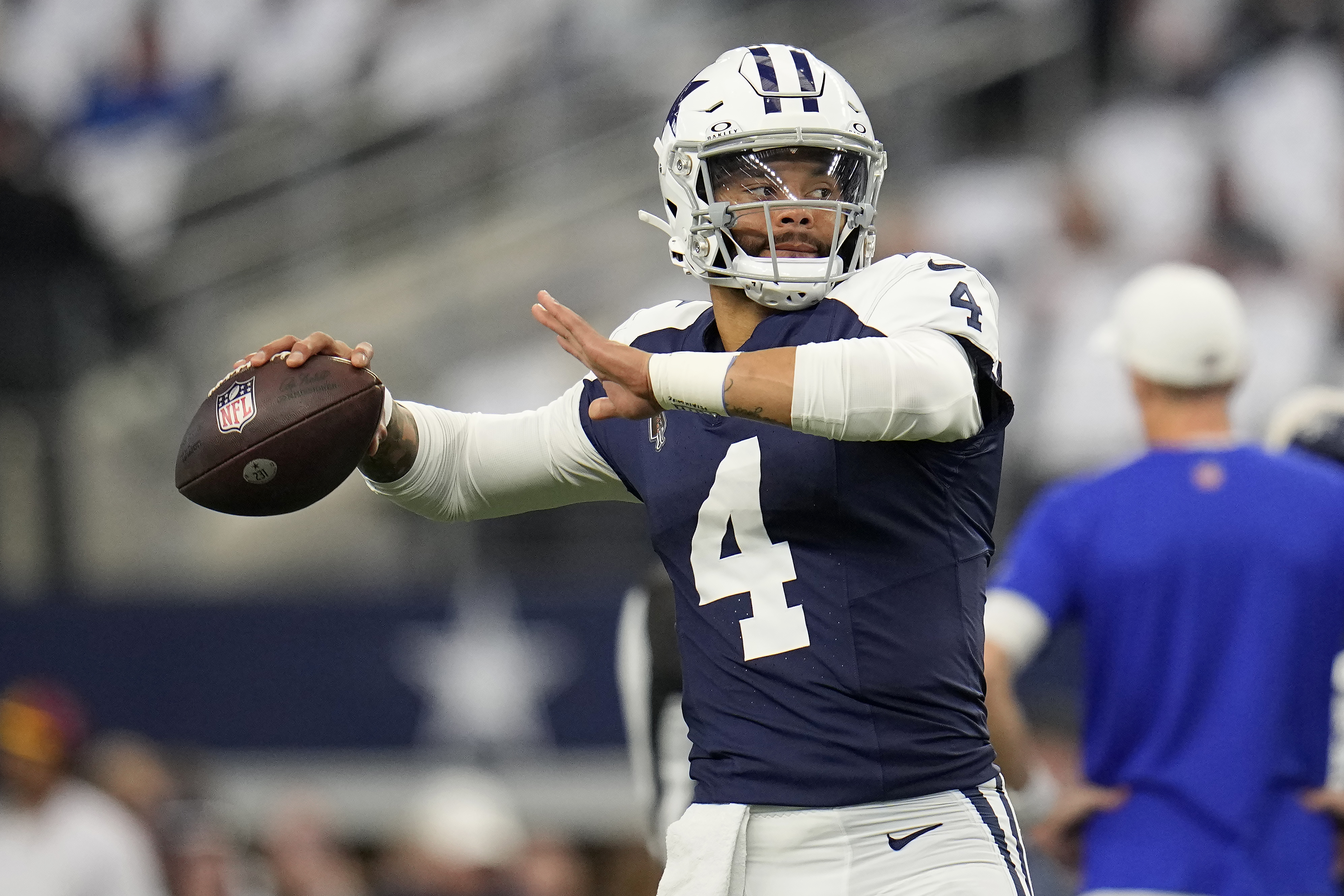 Dallas Cowboys quarterback Dak Prescott warms up before an NFL football game against the Washington Commanders Thursday, Nov. 23, 2023, in Arlington, Texas.