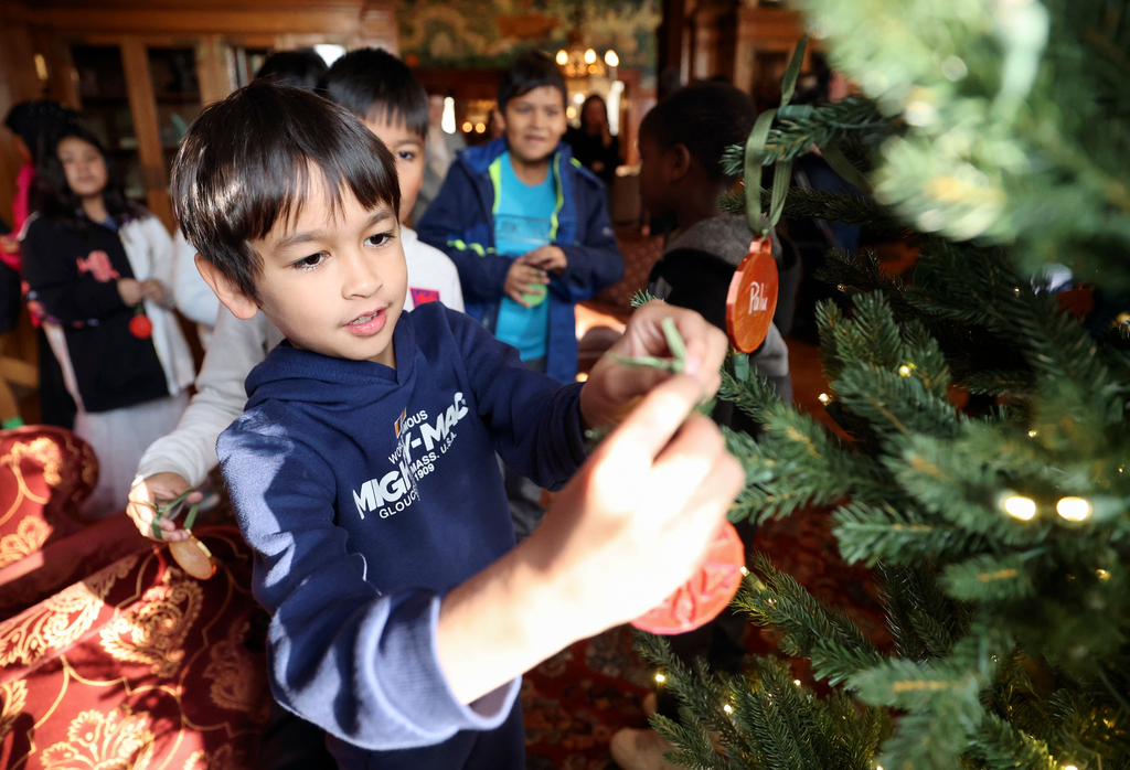 Lincoln Elementary School fourth grader Trevor Ritchie helps decorate a Christmas tree at the Governor’s Mansion in Salt Lake City on Wednesday.