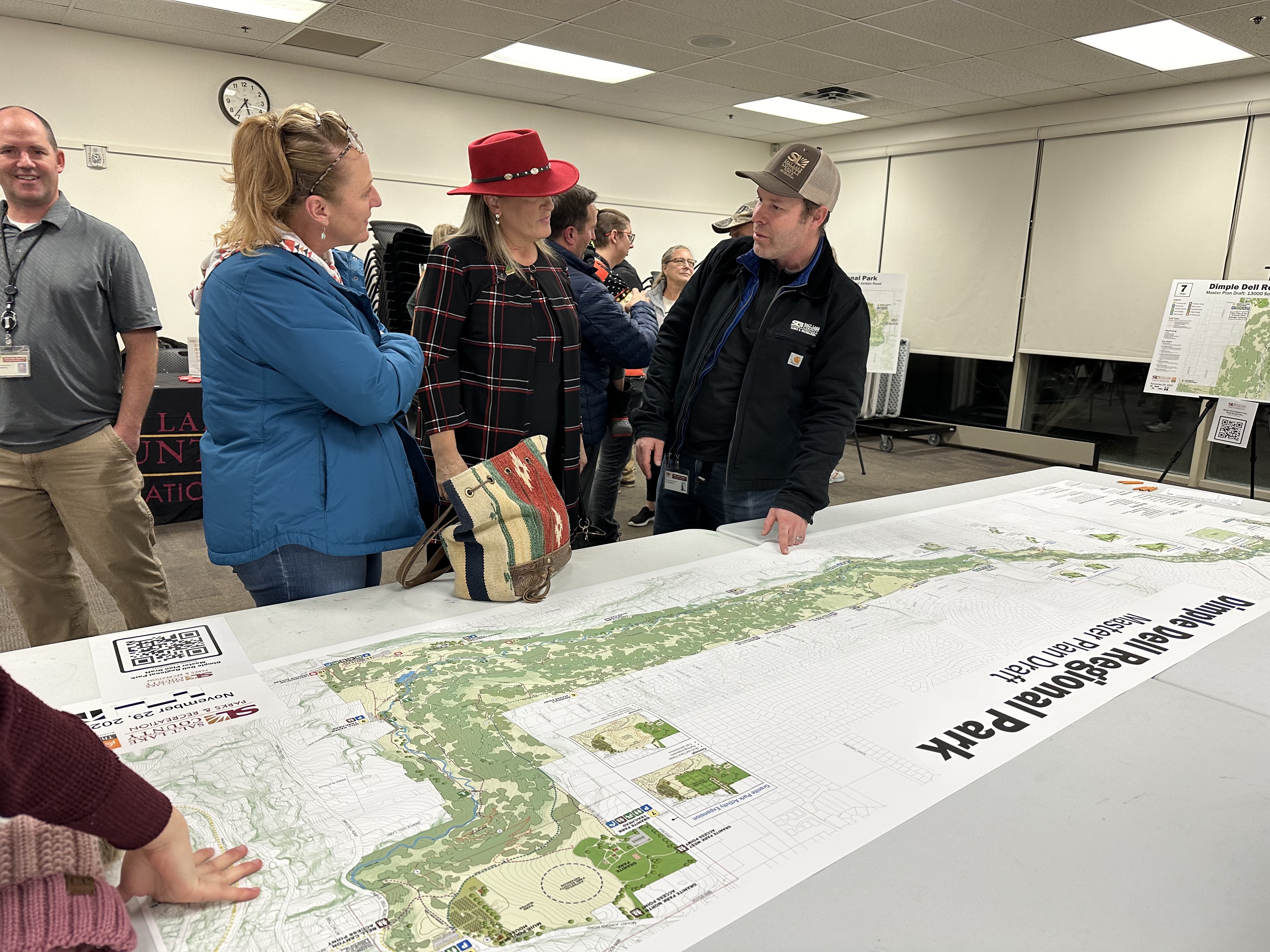Sandy resident Lisa Caddy, Mayor Monica Zoltanski and county park planner Dan Sonntag discuss the Dimple Dell Regional Park's master plan at a public open house Wednesday at the Sandy Library.