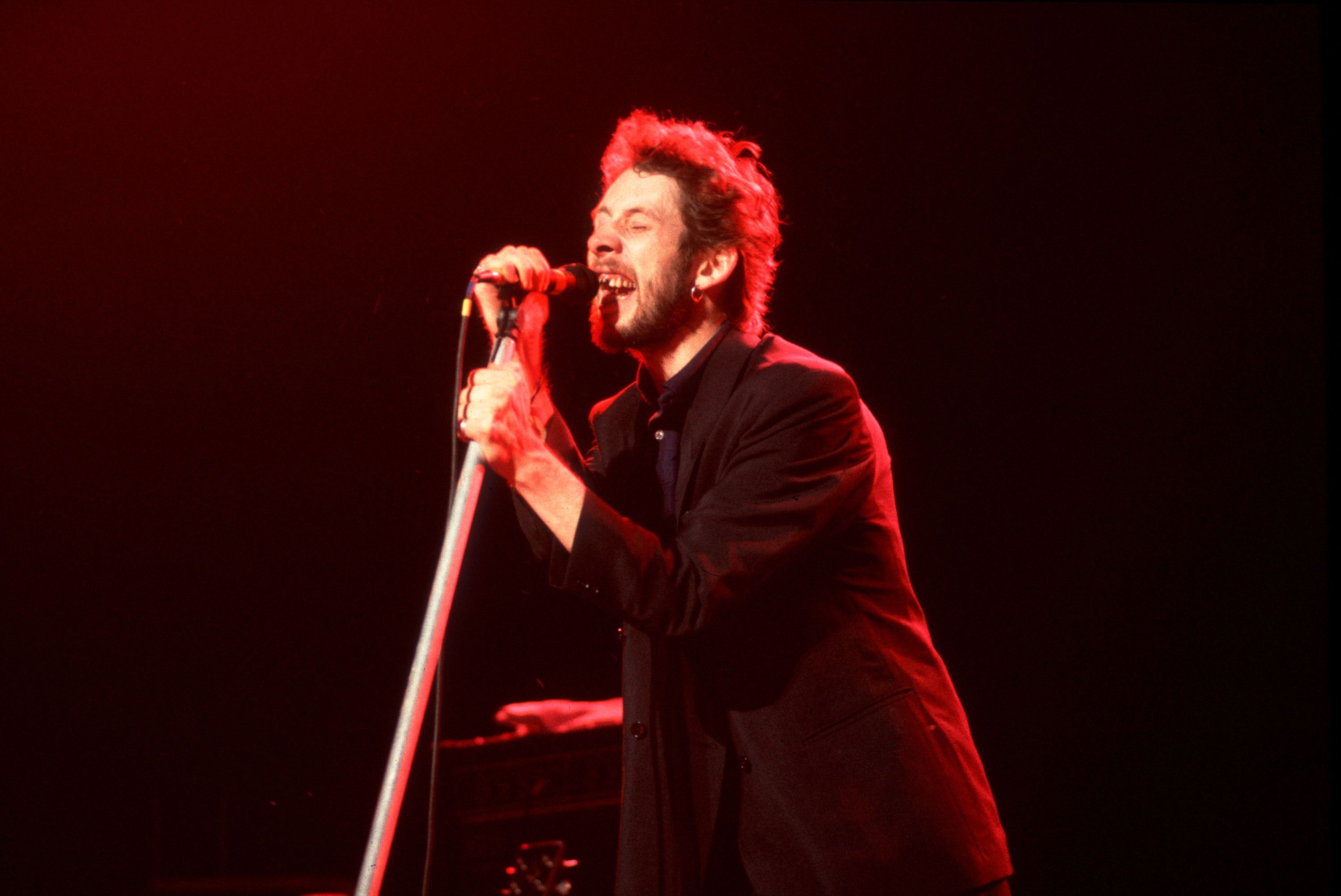 Shane MacGowan, lead singer for The Pogues and pictured here on stage in Chicago in 1986, is dead at 65.
