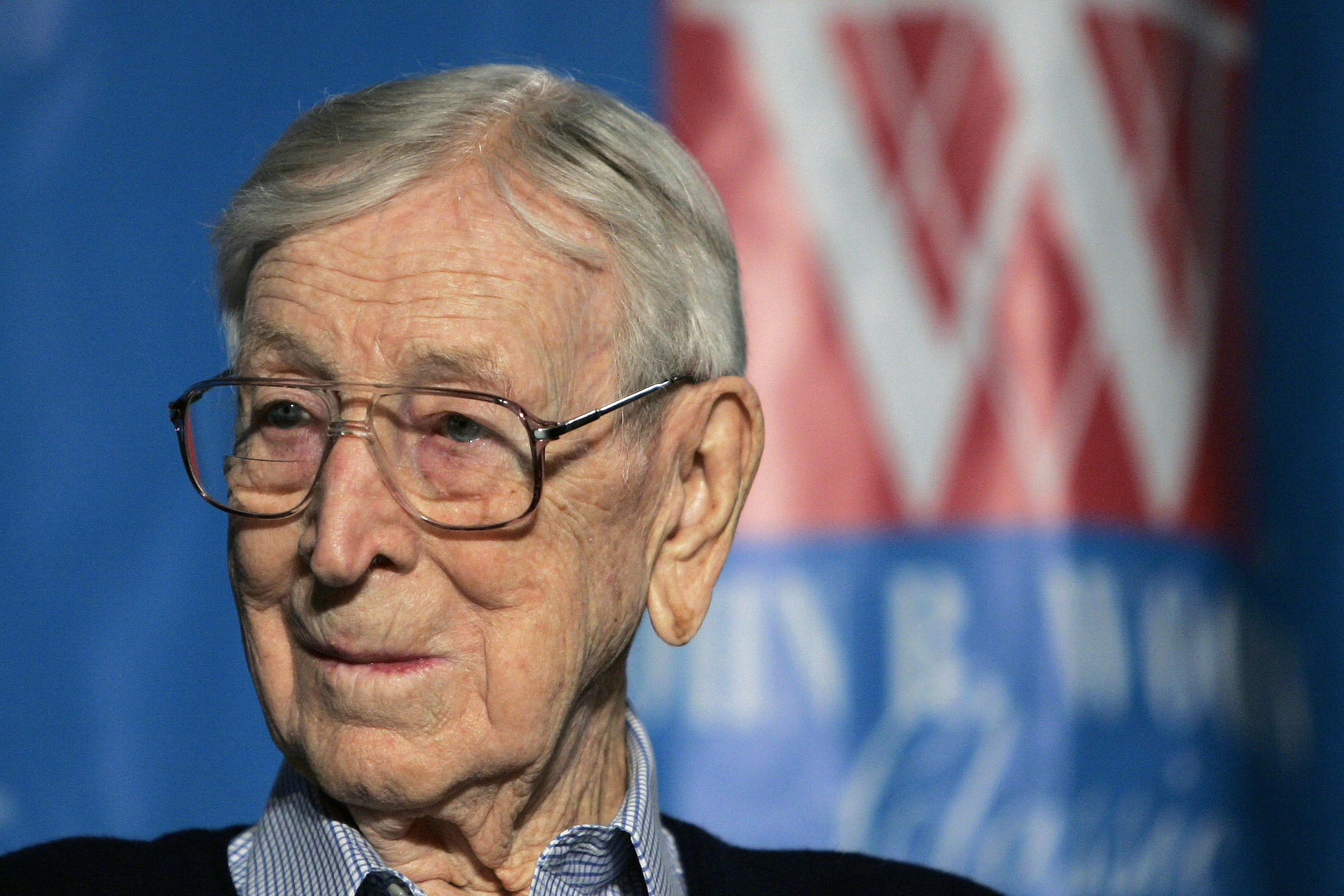 FILE - Former UCLA NCAA college basketball coach John Wooden listens during a news conference in Anaheim, Calif., Dec. 9, 2005. A limited edition stamp honoring the late UCLA basketball coach John Wooden will go on sale early next year. The U.S. Postal Service announced the Wooden stamp on Thursday, Nov. 30, 2023.