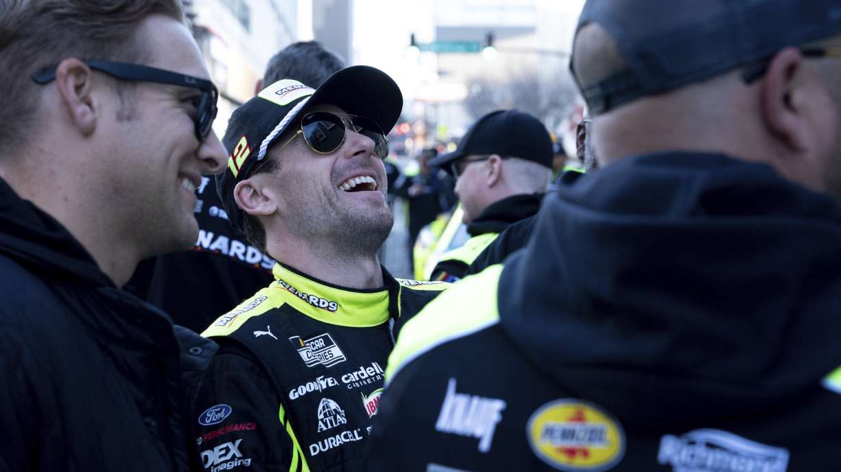 NASCAR Points Champion Ryan Blaney, center, laughs during the NASCAR Champions Car Parade in Nashville, Tenn., Wednesday, Nov. 29, 2023.
