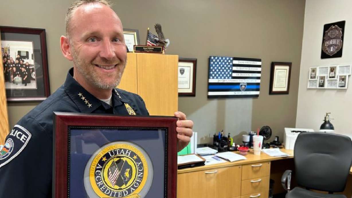 Washington Police Chief Jason Williams holds a plaque from the Utah Chiefs of Police Association in Washington, Nov. 11.