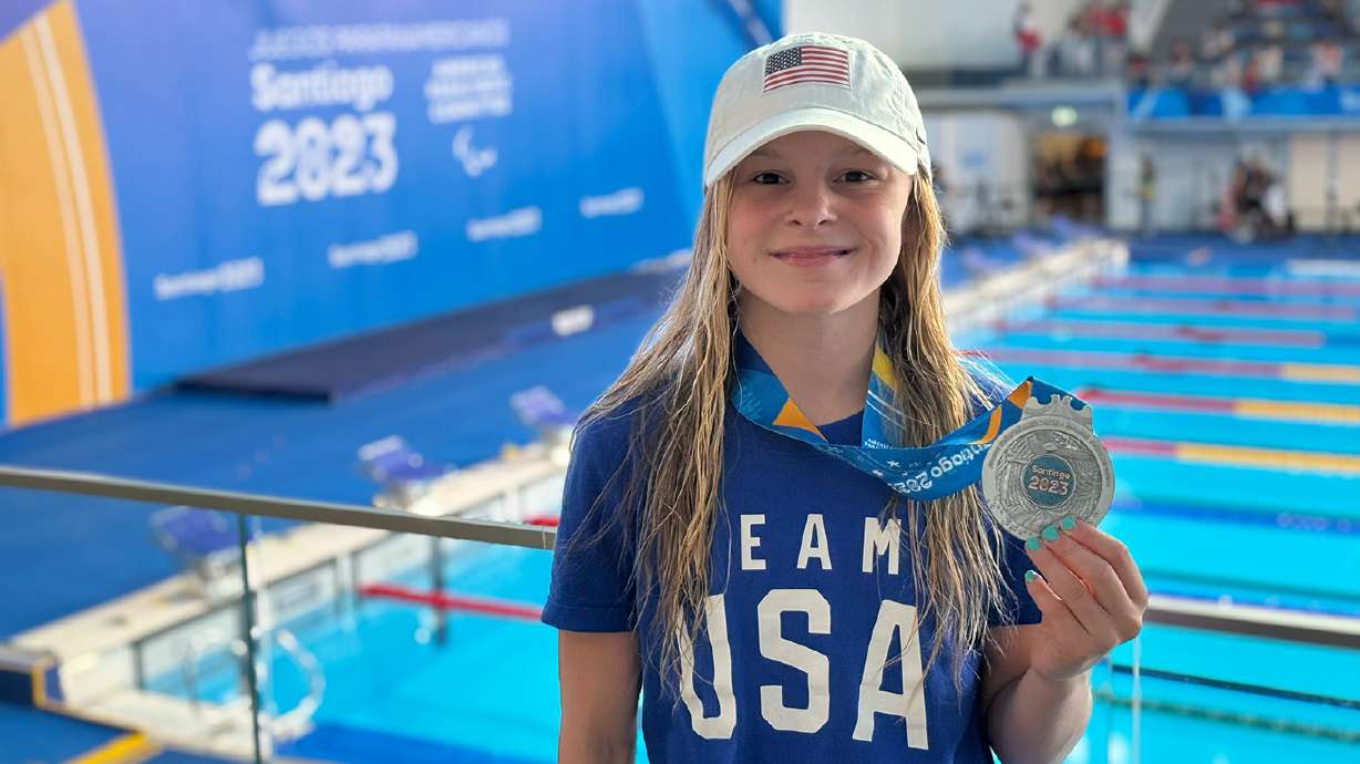 Chloe, an Olympus Jr. High seventh grader, holds up a silver medal she won for the women's 100 meter backstroke event at the Santiago 2023 Parapan American Games in November.