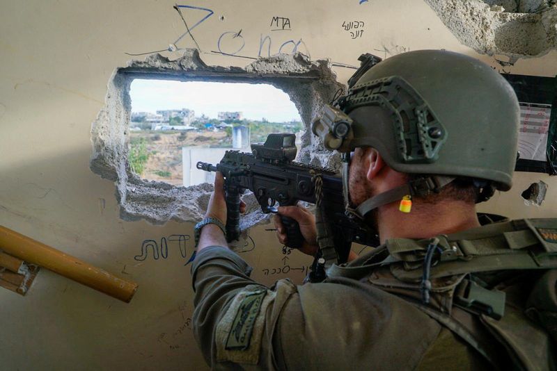 An Israeli soldier aims a weapon as they operate in the Gaza Strip, after a temporary truce between Israel and the Palestinian Islamist group Hamas expired Friday.