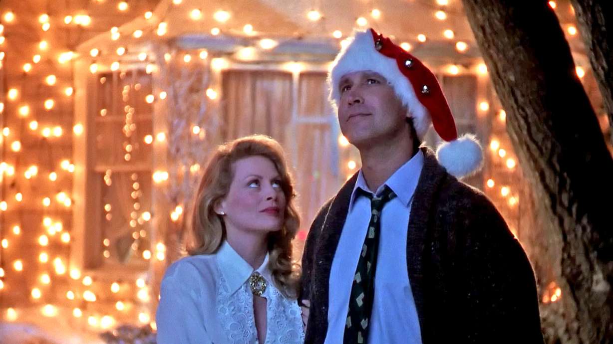 Beverly D'Angelo and Chevy Chase admire his handiwork with holiday lights in "National Lampoon's Christmas Vacation," playing in local theaters this month.