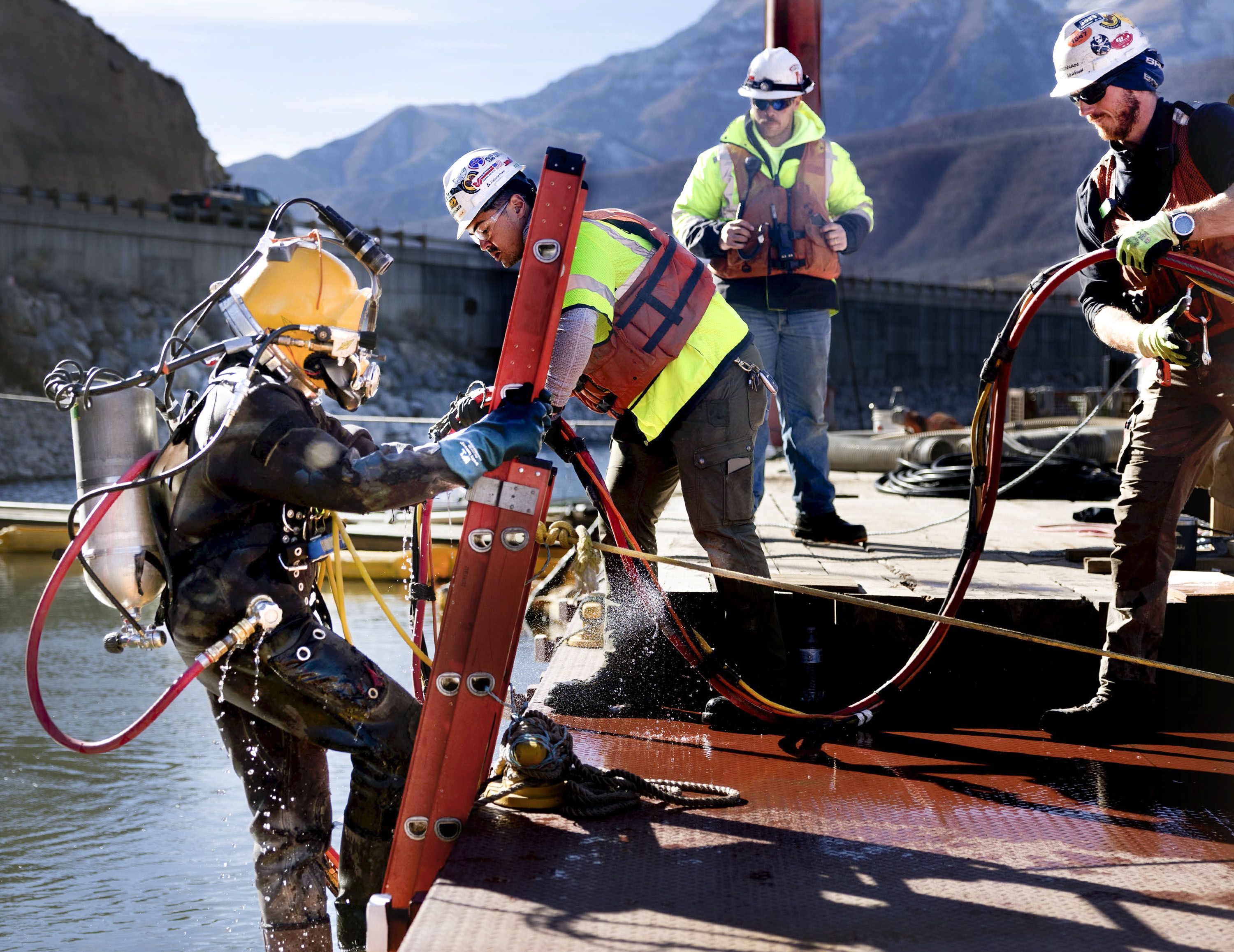 Underwater construction diver Christian Peterson enters the water to grout the panels of the intake structure at the Deer Creek Intake Project in Heber City on Nov. 15.