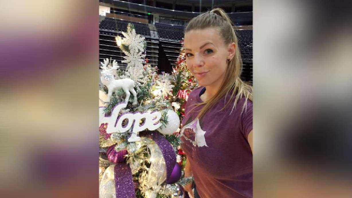 Tamra Rachol stands in front of her tree, Hope, in 2020. Rachol, a survivor of domestic violence, sees the Festival of Trees as a space to shed light on topics that are often left behind closed doors and to provide hope for others.