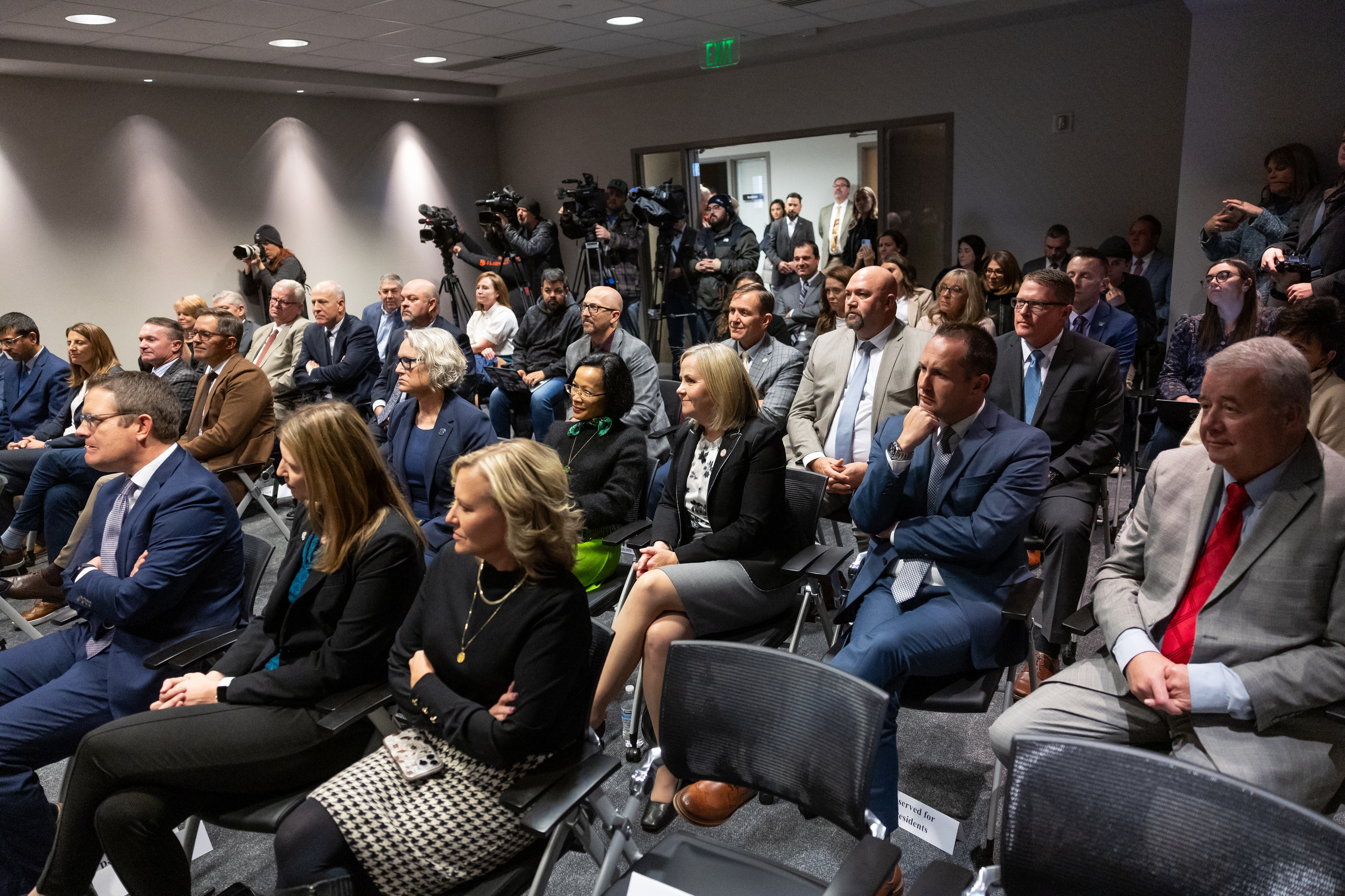 People listen during a press conference about campus free speech at the Utah System of Higher Education office in Salt Lake City on Friday.