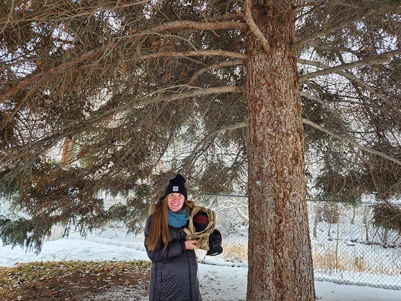 Zoey Prestwich in front of the tree where she found the treasure last December.