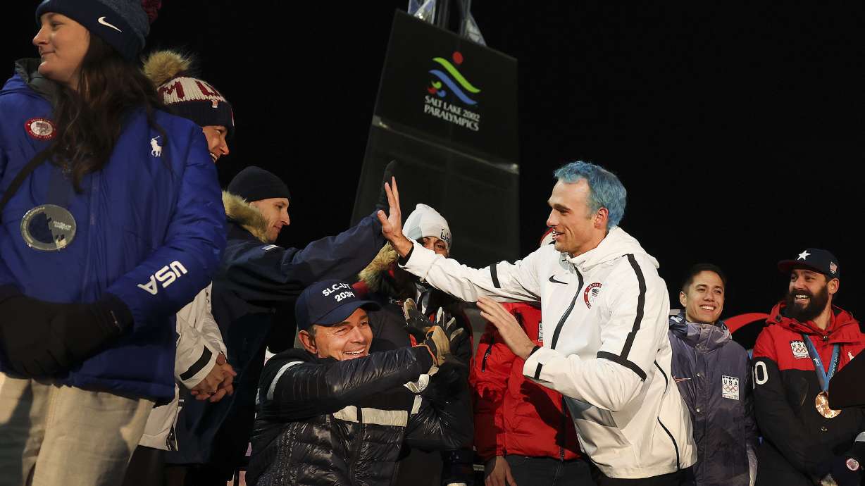 Olympic medalists greet one another as the Salt Lake City-Utah Committee for the Games hosts an Olympic and Paralympic Cauldron Lighting at Rice-Eccles Stadium in Salt Lake City on Friday, to celebrate Utah’s ambitions to host another Games.