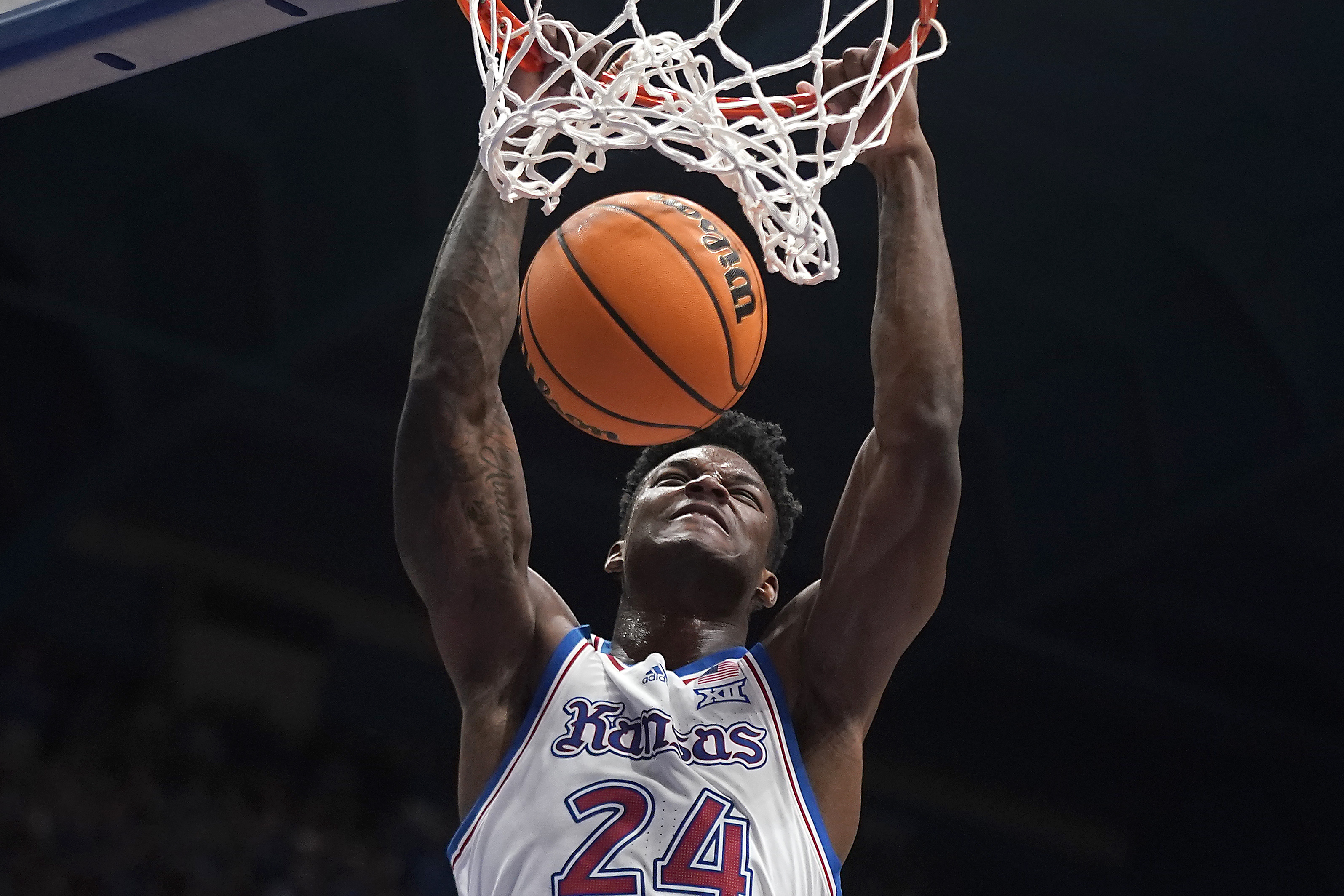 Kansas forward K.J. Adams Jr. dunks the ball during the first half of an NCAA college basketball game against UConn Friday, Dec. 1, 2023, in Lawrence, Kan.