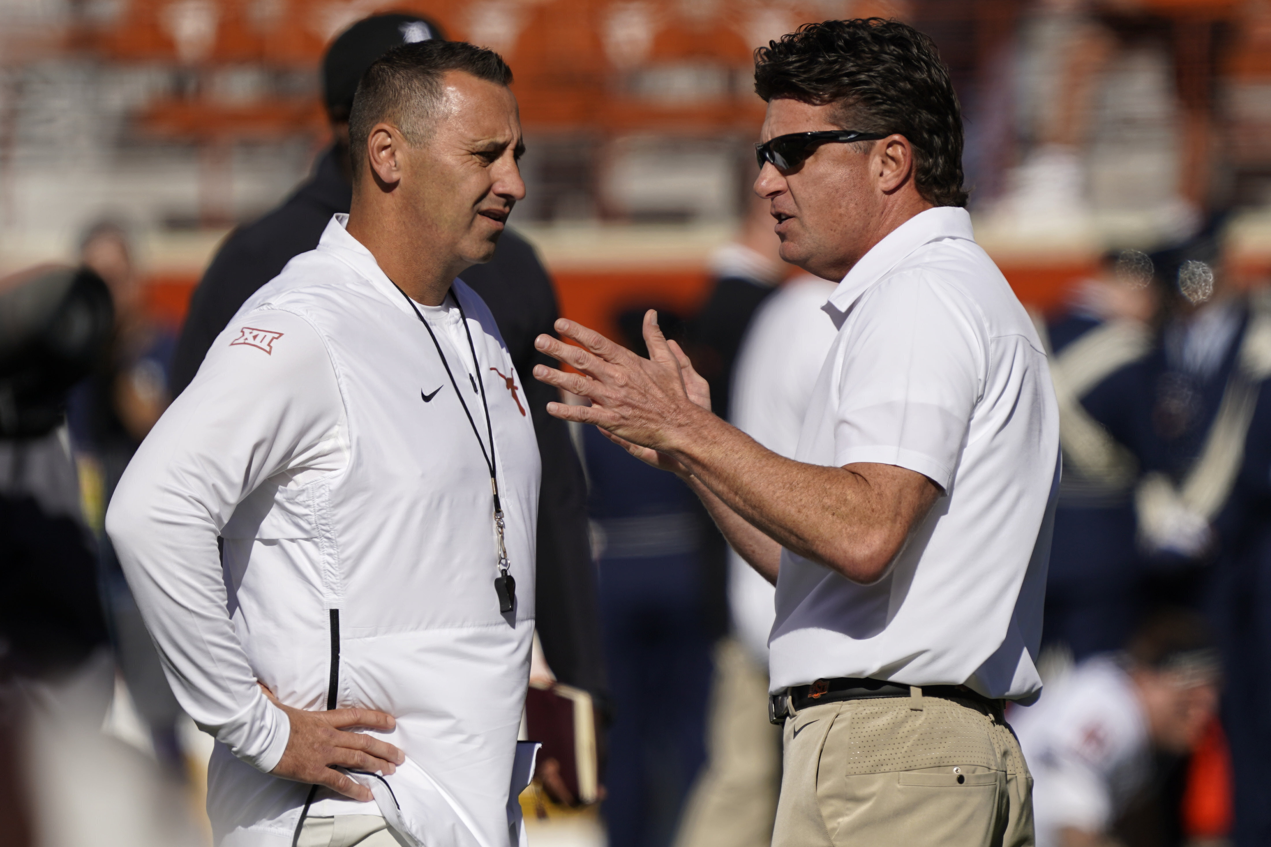 FILE - Texas head coach Steve Sarkisian, left, talks with Oklahoma State head coach Mike Gundy, right, before an NCAA college football game in Austin, Texas, Saturday, Oct. 16, 2021. Texas will try to bid farewell to the Big 12 with a bookend title. The seventh-ranked and SEC-bound Longhorns won the inaugural Big 12 championship game in 1996, and now play their last one against No. 19 Oklahoma State on Saturday, Dec. 2, 2023. 