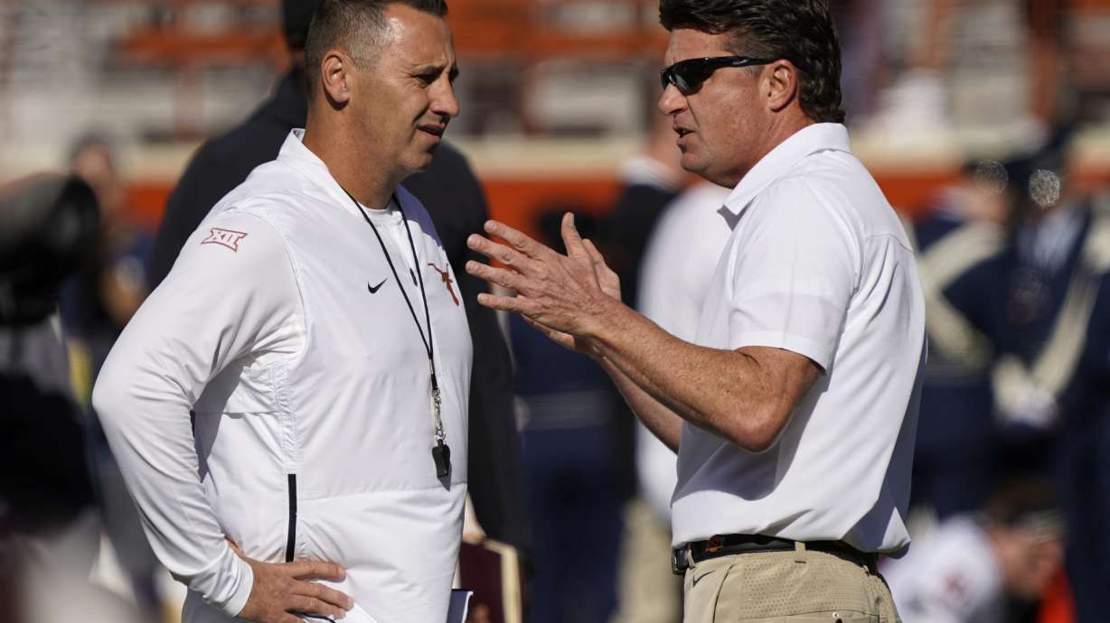 FILE - Texas head coach Steve Sarkisian, left, talks with Oklahoma State head coach Mike Gundy, right, before an NCAA college football game in Austin, Texas, Saturday, Oct. 16, 2021. Texas will try to bid farewell to the Big 12 with a bookend title. The seventh-ranked and SEC-bound Longhorns won the inaugural Big 12 championship game in 1996, and now play their last one against No. 19 Oklahoma State on Saturday, Dec. 2, 2023.