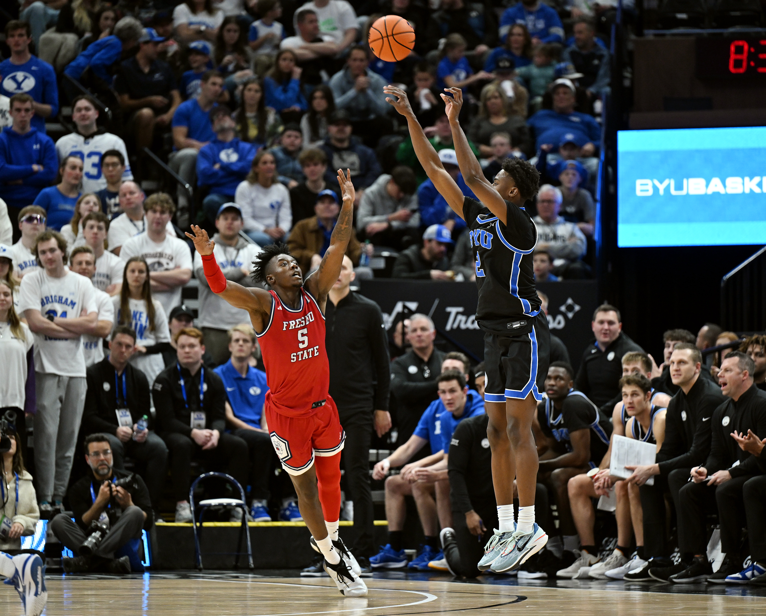 BYU Cougars guard Jaxson Robinson (2) puts up a 3-pointer over Fresno State Bulldogs guard Jalen Weaver (5) during a game at the Delta Center in Salt Lake City on Friday, Dec. 1, 2023. BYU won 85-56.